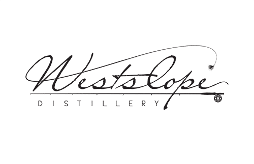 Logo of Westslope Distillery featuring elegant cursive script. The "Westslope" text is stylized with a fishing fly design at the end of the "e." Below, "Distillery" is written in capital letters.