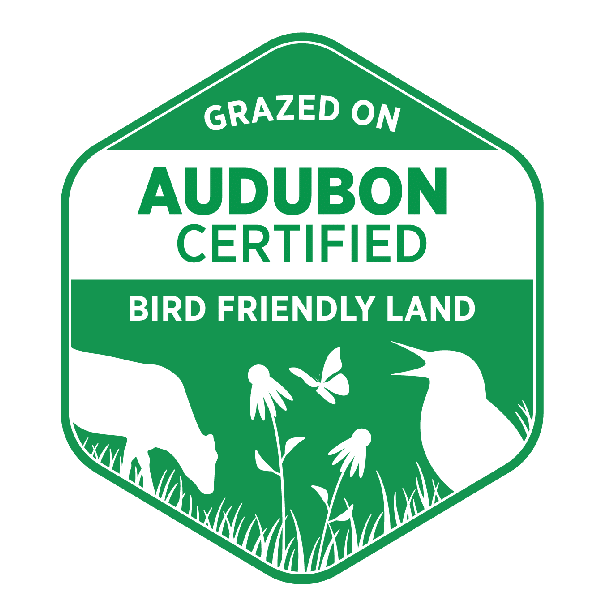 A green and white badge reads "Grazed on Audubon Certified Bird Friendly Land" with silhouettes of a cow, flowers, a butterfly, and a bird.