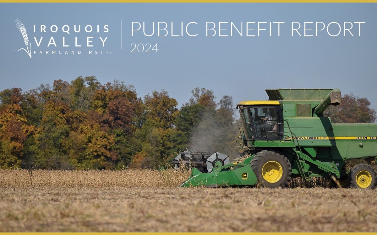 A green combine harvester works in a field of harvested crops under a clear sky, with trees in autumn colors in the background. Text reads: “Iroquois Valley Farmland REIT Public Benefit Report 2024.”.