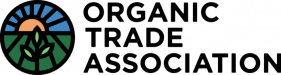 Logo of the Organic Trade Association featuring a circular design with a sunrise over fields and a plant, next to the text "ORGANIC TRADE ASSOCIATION" in bold black letters.